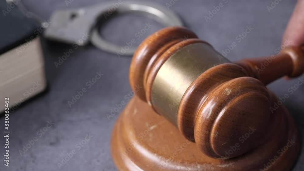 close up of person's hand striking the gavel. close up of person's hand striking the gavel.