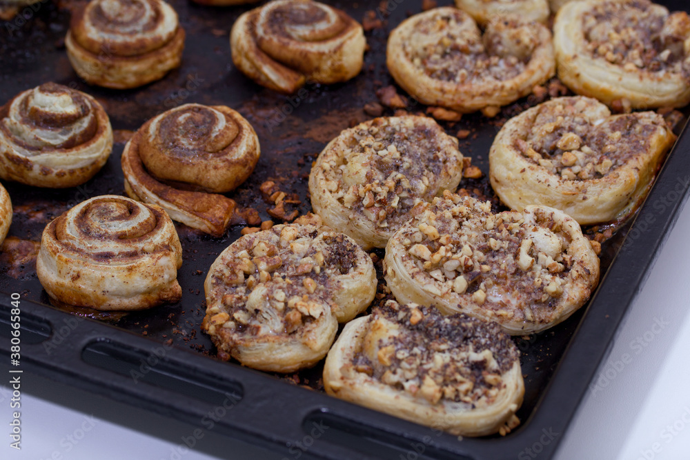 Baked buns stuffed with poppy, cinnamon and walnuts. Lie on a baking sheet. Cooking buns. Baked buns stuffed with poppy, cinnamon and walnuts. Lie on a baking sheet. Cooking buns.