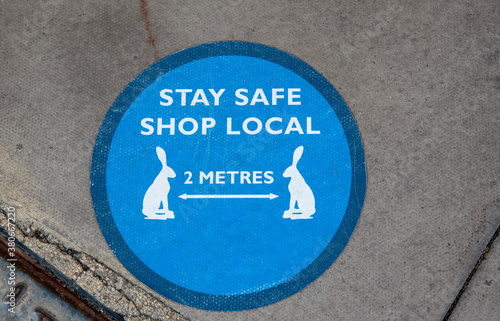 Tetbury, Gloucestershire, England, UK. 2020. Stay safe and shop local sign on the pavement in Tetbury town centre during Coronavirus epidemic. photo