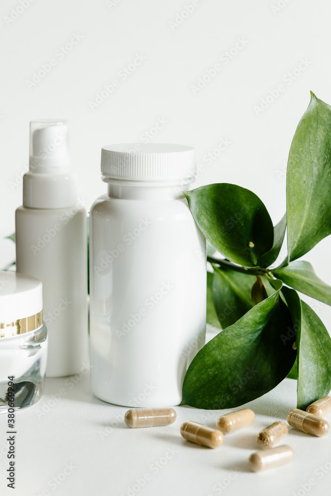 Herb capsules and white bottles, healthcare and beauty concept. Herb capsules and white bottles, healthcare and beauty concept.