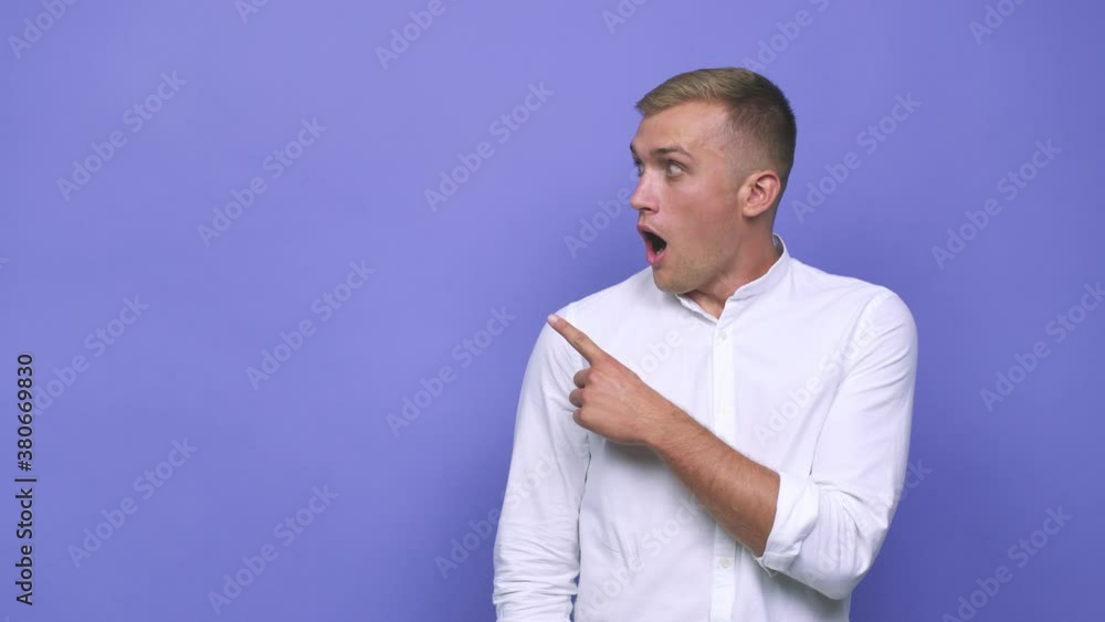 Young caucasian man pointing to the side Young caucasian man pointing to the side