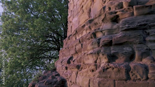 Slow motion shot on the edge of a rock wall and idyllic trees photo