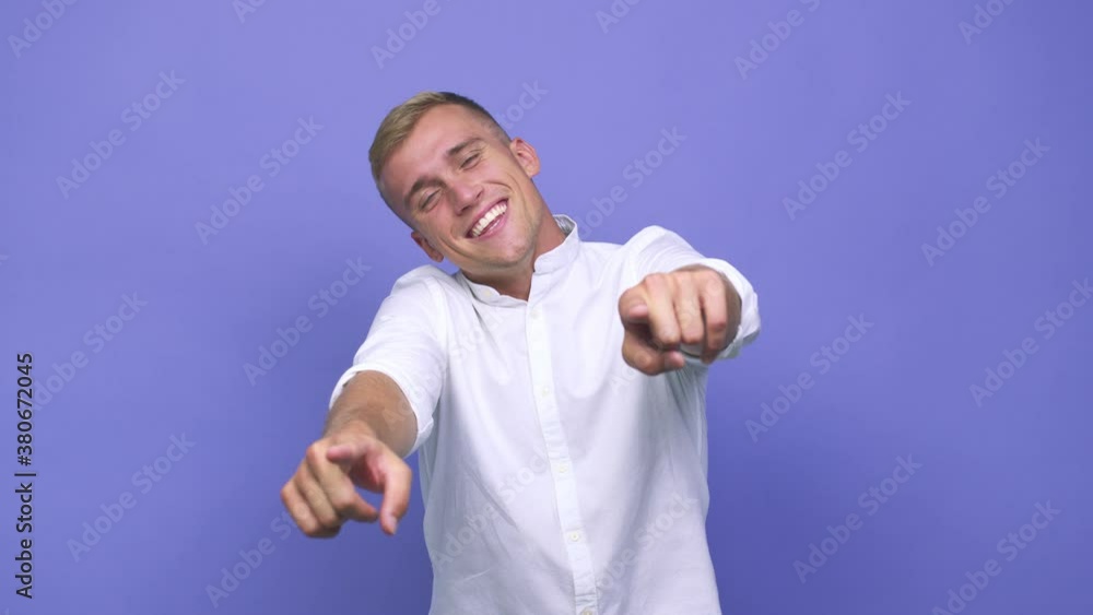 Young caucasian man cheerful smiles pointing to front Young caucasian man cheerful smiles pointing to front