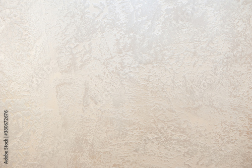 Wall decor Venetian decorative plaster with golden glitter paint. Background, abstraction. Apartment renovation concept.