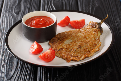 Eggplant Omelette or Tortang Talong is a Filipino dish consists simply of eggplant that is coated in egg and then fried close-up on a plate. Horizontal photo