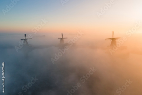 Zaanse schans in the morning mist during sunrise © Teun