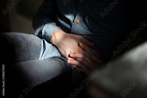 Hands folded together. The man clasped his hands together. The guy is holding his fingers. Significant closure gesture.
