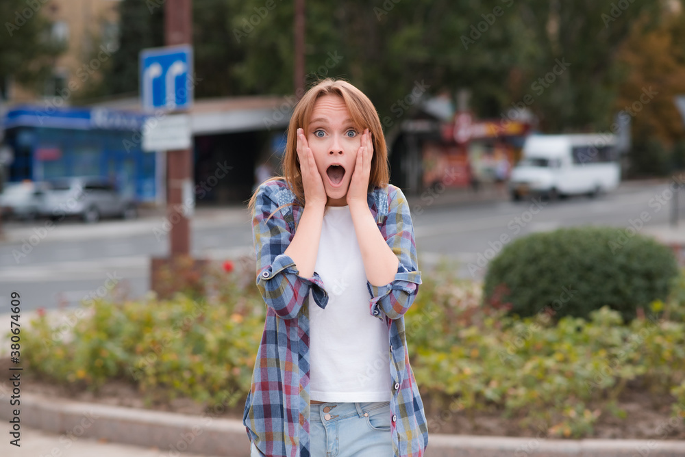 Portrait of a beautiful girl on the street who shows surprise Portrait of a beautiful girl on the street who shows surprise