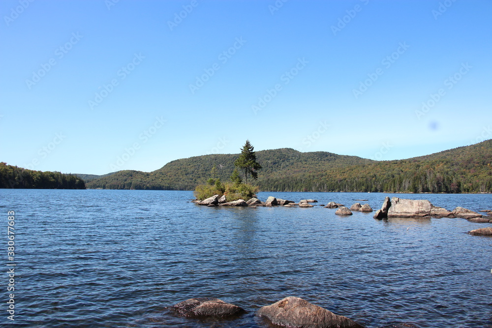 Adirondack lake with island containing rocks and trees
