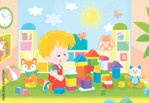 Happy little boy playing with color bricks and constructing a funny toy fortress for game in a playroom of a kindergarten, vector cartoon illustration