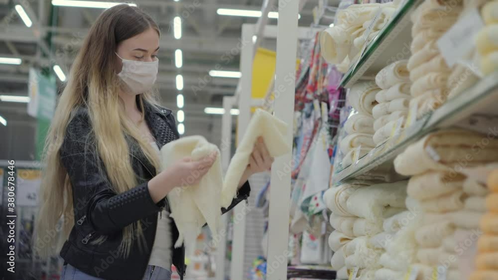 female customer in household goods department, choosing towels female customer in household goods department, choosing towels