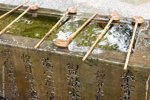 Kamakura, Japan. The Temizu-ya or Chouzu-ya, a Shinto water ablution pavilion at the entrance of Kotoku-in temple photo