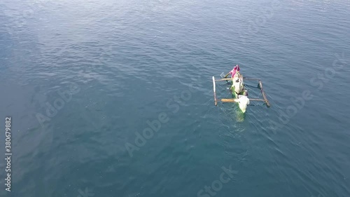 Men riding on the boat. Aerial footage on the sea. photo