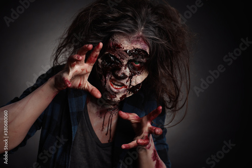 Scary zombie on dark background. Halloween monster