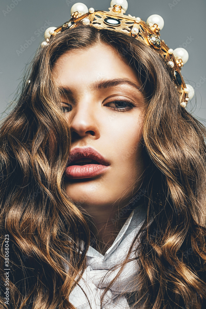 Fototapeta premium beautiful woman with curly hair in golden crown