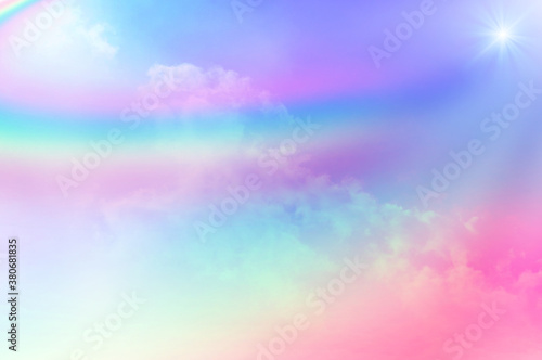 The Rainbow sky is Colorful sky with Soft clouds and a rainbow crossing. Fantasy magical sunny sky pastel background is fluffy white cloud. Freedom wallpaper concept. Sweet color dream.