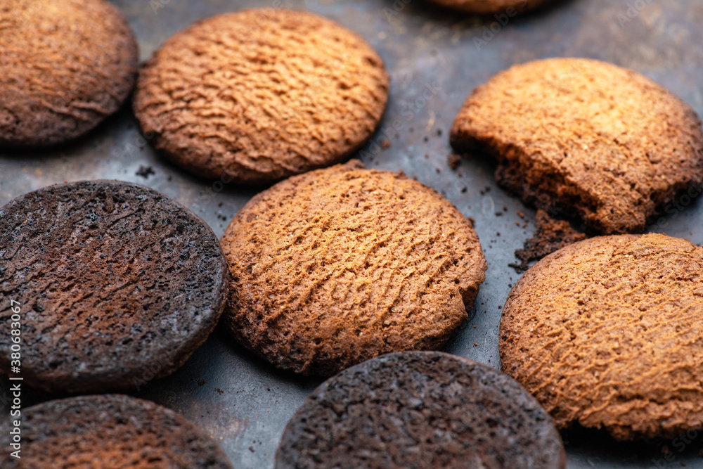 Burnt cookies. Burnt oatmeal cookies lie on a black baking sheet. Burnt cookies. Burnt oatmeal cookies lie on a black baking sheet.