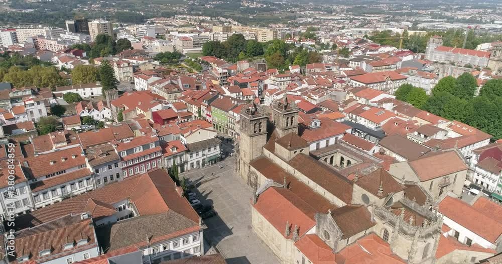 Overflying The Red Roof Buildings In The City Of Braga Towards The Historic Braga Cathedral (Se De Braga) On A Sunny Day In Portugal. - aerial Overflying The Red Roof Buildings In The City Of Braga Towards The Historic Braga Cathedral (Se De Braga) On A Sunny Day In Portugal. - aerial