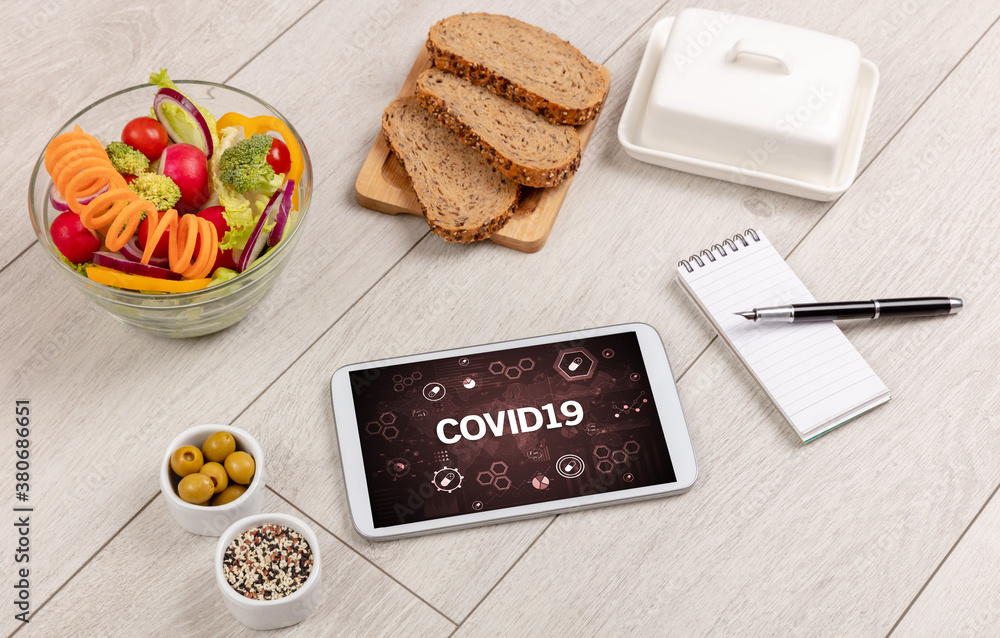 Fototapeta premium Healthy Tablet Pc compostion with COVID19 inscription, immune system boost concept
