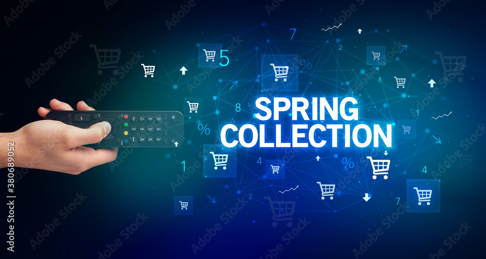 hand holding wireless peripheral with SPRING COLLECTION inscription, online shopping concept hand holding wireless peripheral with SPRING COLLECTION inscription, online shopping concept