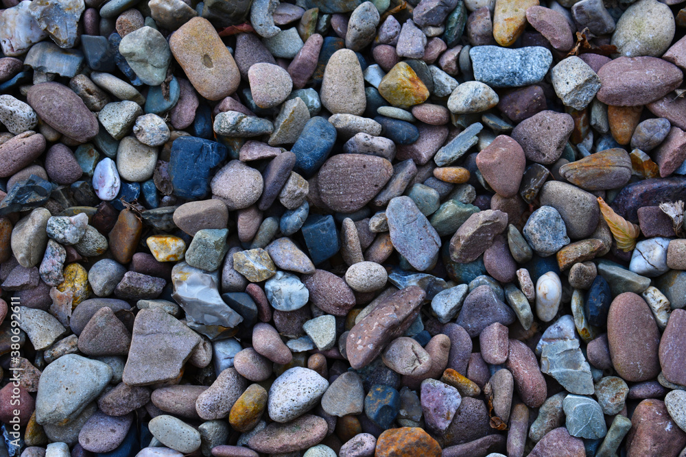 colourful stones pebbles with different sizes and shapes making texture for the background colourful stones pebbles with different sizes and shapes making texture for the background