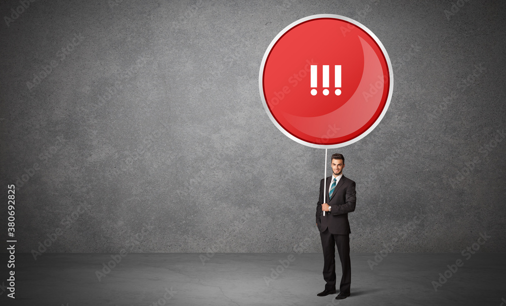 Obraz premium Young business person holdig traffic sign with !!! abbreviation, technology solution concept