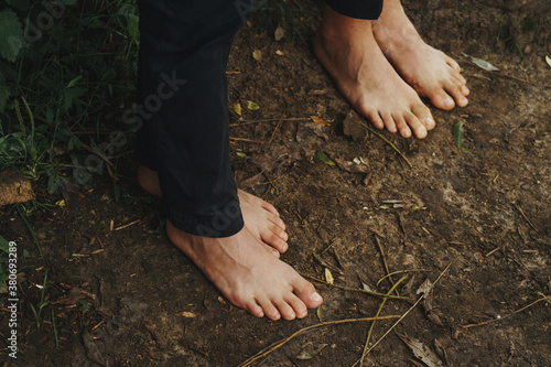 top view of bare feet standing on damp ground