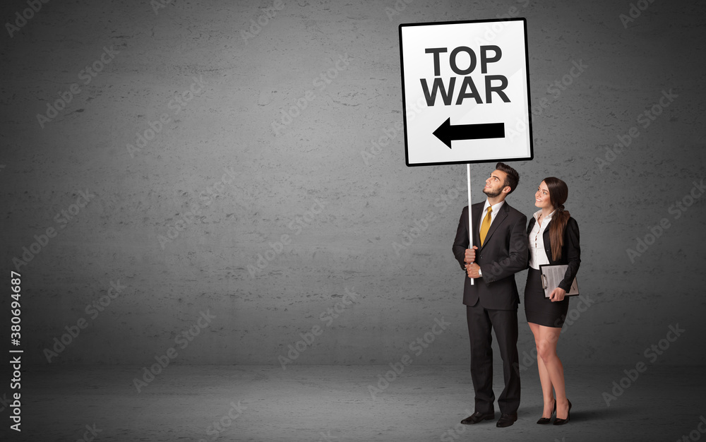 business person holding a traffic sign with TOP WAR inscription, new idea concept business person holding a traffic sign with TOP WAR inscription, new idea concept