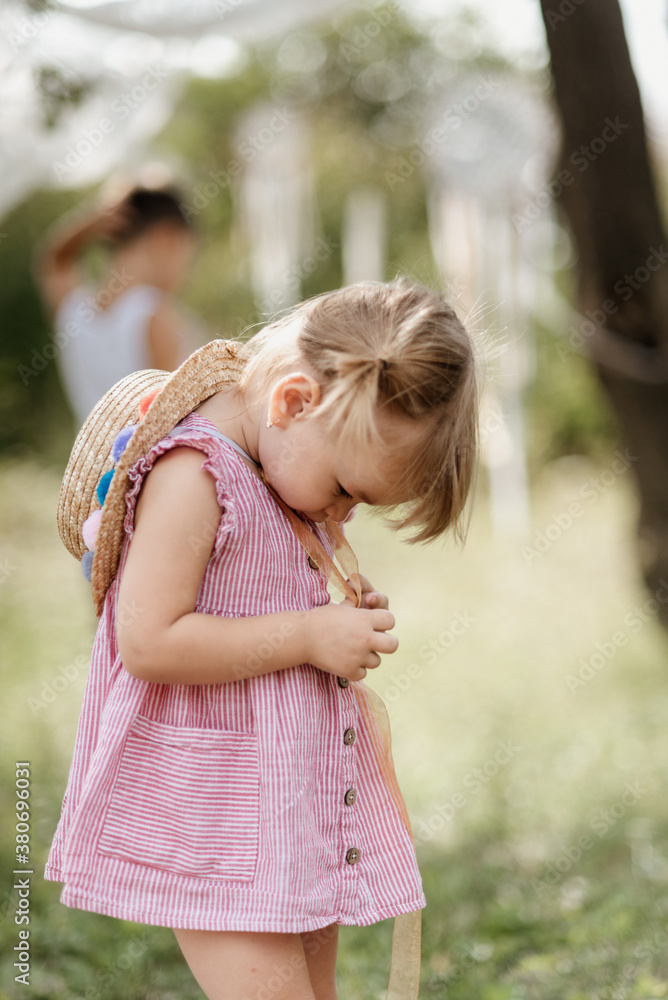 Toddler girl is playing outside on the summer day Toddler girl is playing outside on the summer day