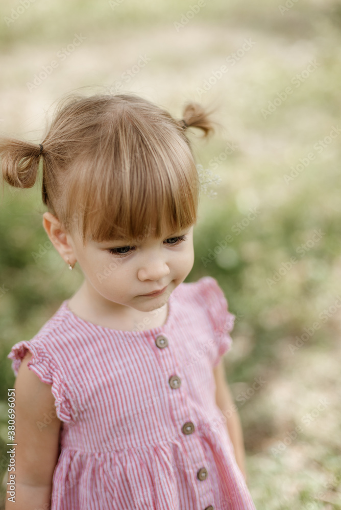 Toddler girl is playing outside on the summer day Toddler girl is playing outside on the summer day