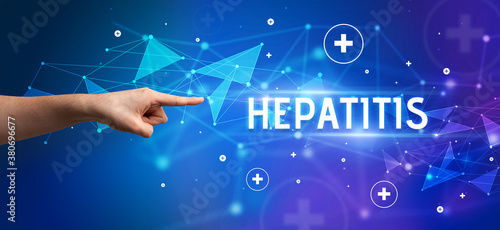 Close-Up of cropped hand pointing at HEPATITIS inscription, medical concept