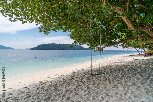 scenic view of beautiful Sai Khao (white sand) Beach with swing in Ra Wi Island, Southern of Thailand