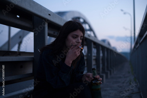 cinematic photo of a girl on a night bridge photo