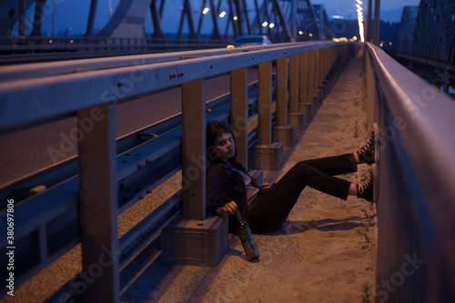 cinematic photo of a girl on a night bridge photo