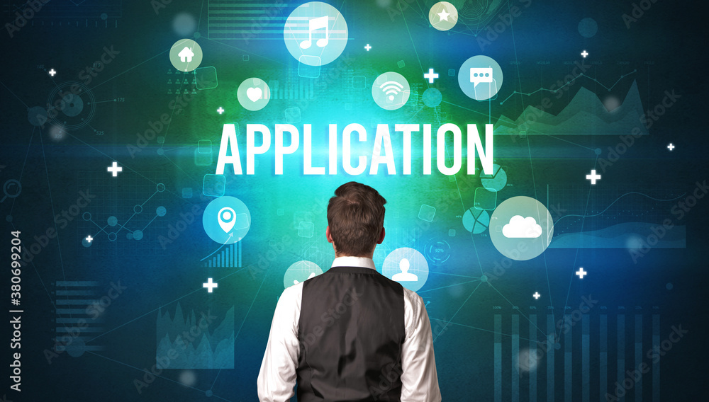 Rear view of a businessman with APPLICATION inscription, modern technology concept Rear view of a businessman with APPLICATION inscription, modern technology concept