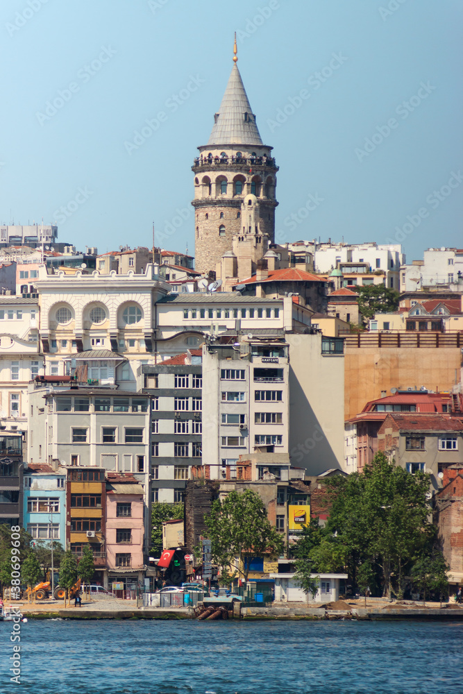 Istanbul, Turkey / May 9, 2016:  Historical Galata tower with buildings near the Bosphorus.