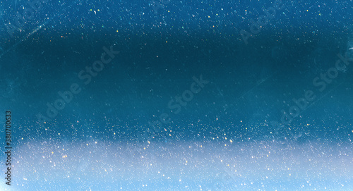 Christmas abstract background. Blur glitter. Iridescent sequins on blue scratched surface.