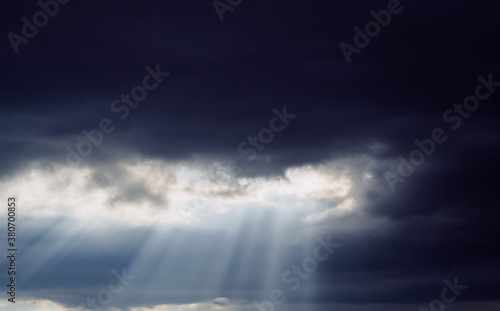 Sunbeams through the clouds during a cloudy day © gonzagon