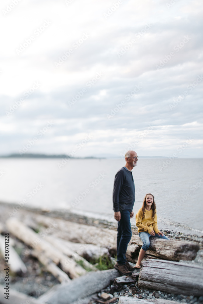Grandfather playing with grandkid outside.
