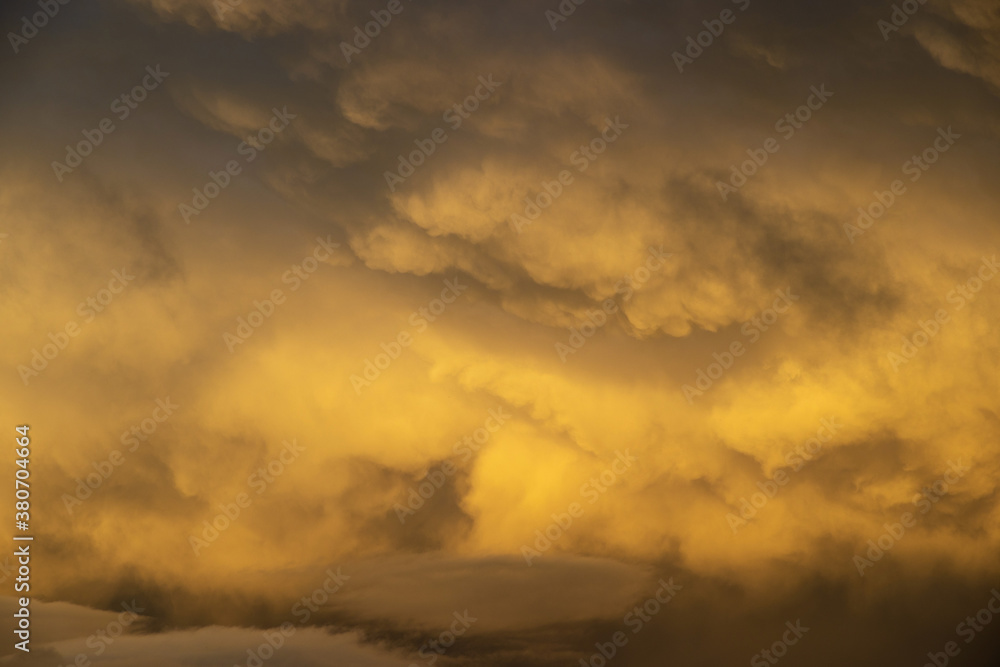 Fototapeta premium Dramatic Orange Light on a Cloud filled sky