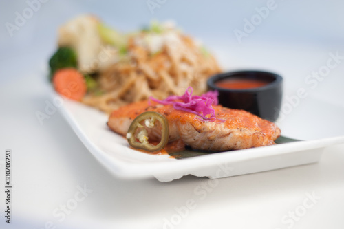 grilled salmon with vegetables in white background
