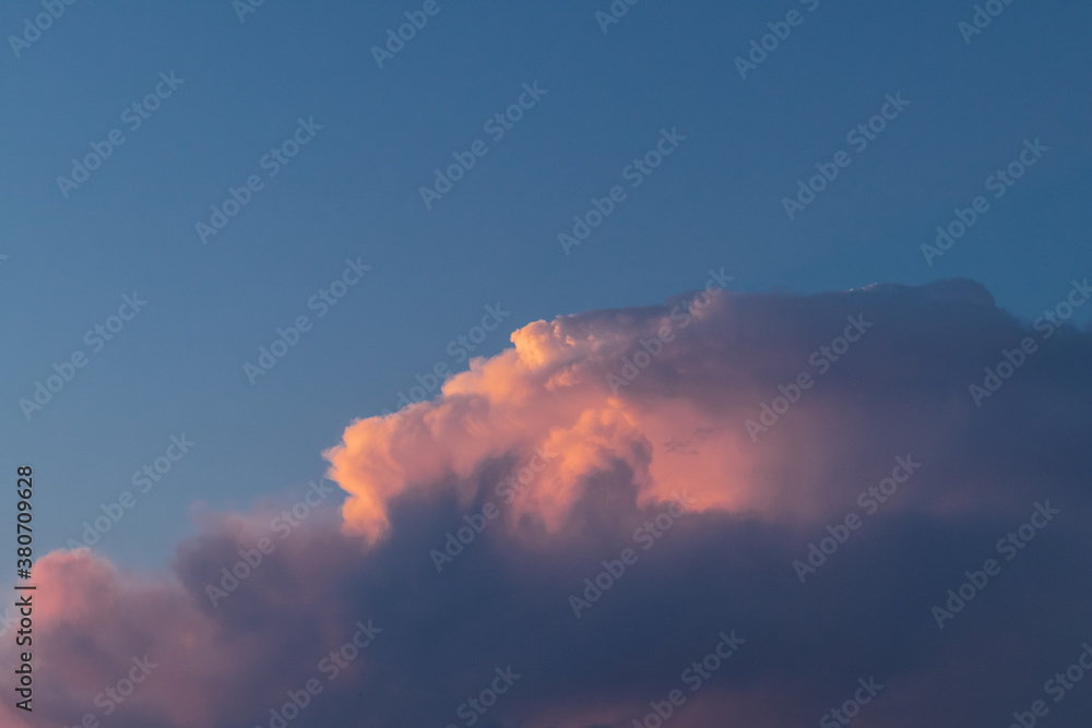 Colorful clouds at sunset in blue sky.