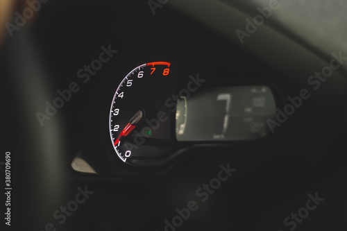 A close-up of a car panel with a speedometer photo