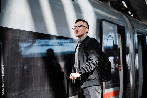 Businessman waiting for train at train station photo