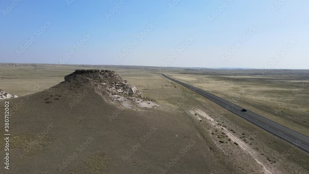Road through dry grasslands in Wyoming (Aerial 4K video) Road through dry grasslands in Wyoming (Aerial 4K video)