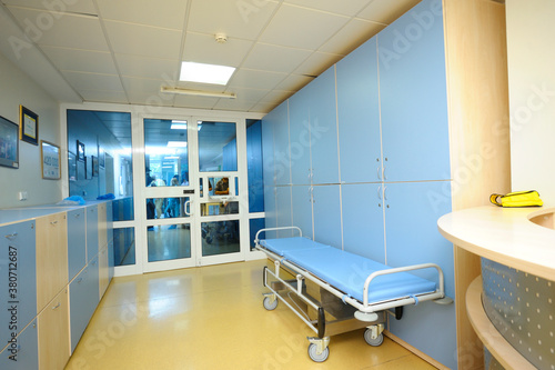 Fototapeta Naklejka Na Ścianę i Meble -  An admission department of a hospital. Transport cart, lockers for patients personal belongings, glass doors
