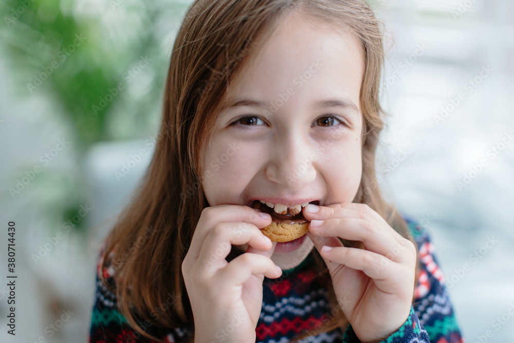 Cute young girl eating a cookie Cute young girl eating a cookie