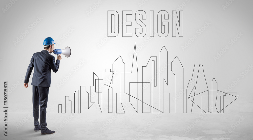 Businessman in hard hat holding blueprint with DESIGN inscription, engineering and architecture concept Businessman in hard hat holding blueprint with DESIGN inscription, engineering and architecture concept