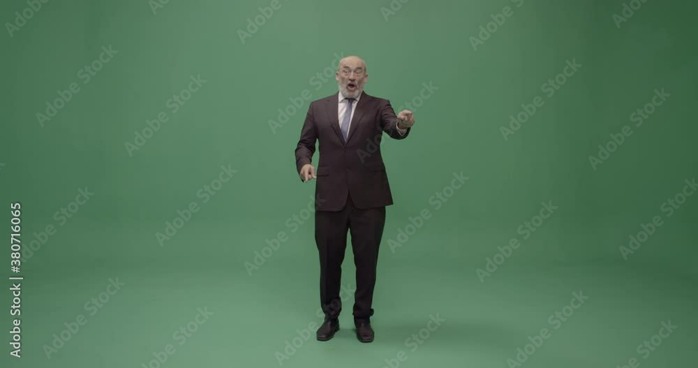 Studio, slow motion, green screen, angry mature man shouts at an audience, London, UK Studio, slow motion, green screen, angry mature man shouts at an audience, London, UK