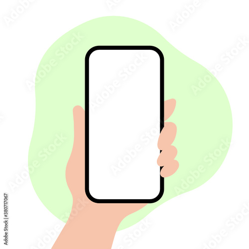 Hand holding a phone on a green background